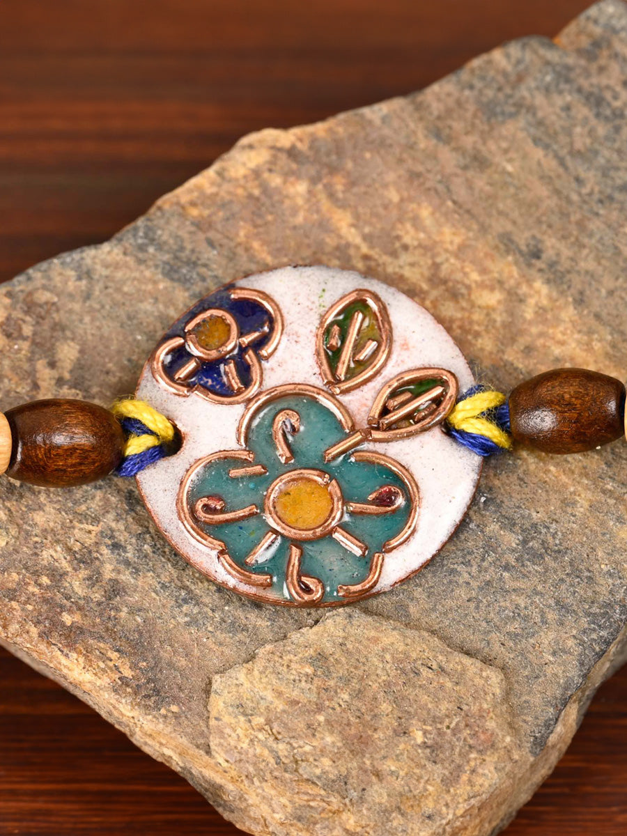 Shop Handcrafted "Phool" Copper Enamel Rakhi by EkiBeki