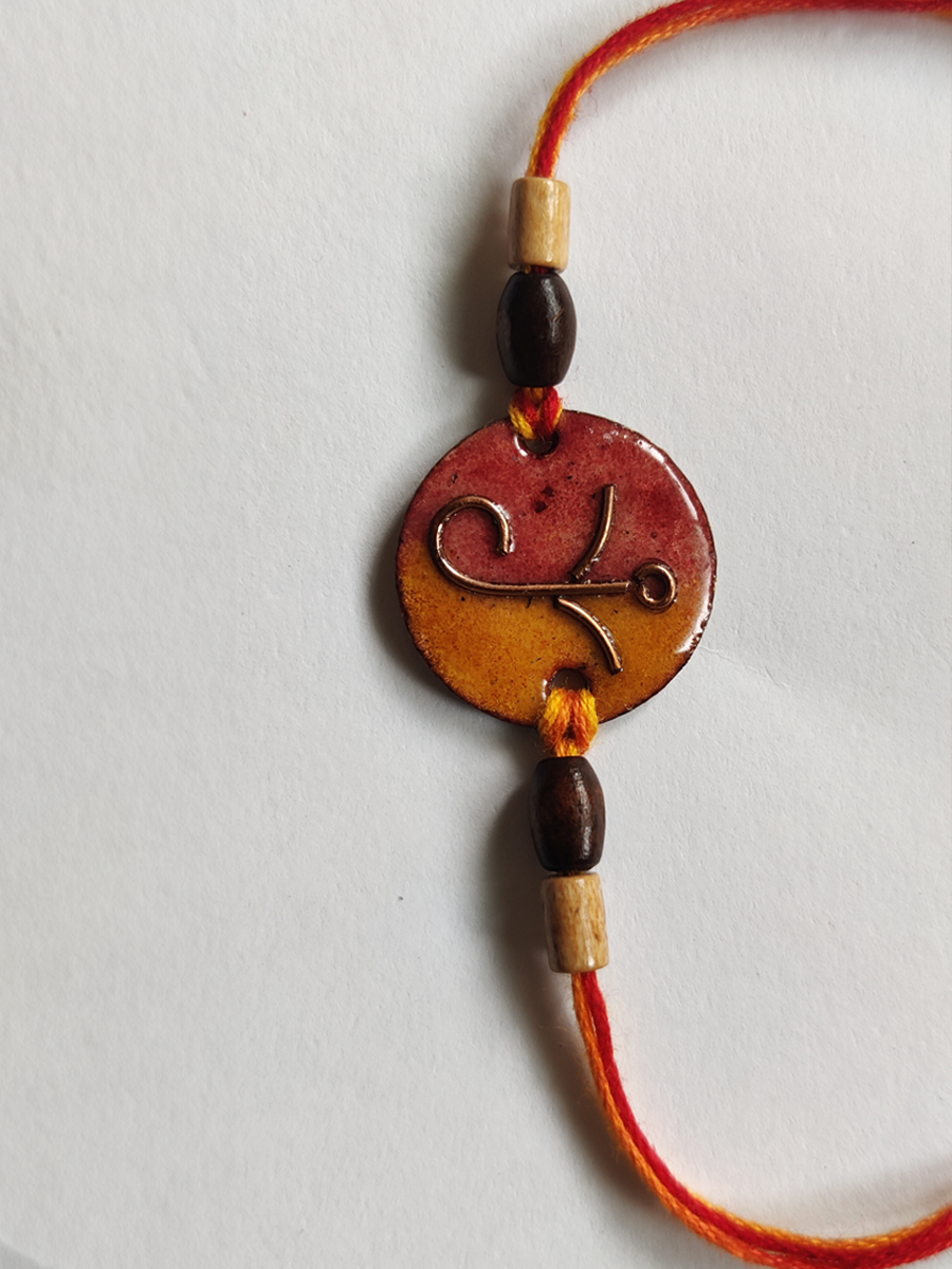 Buy Yellow - Orange Round Ganesha Rakhi