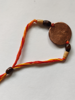 buy Handcrafted Swastika Copper Enamel Rakhi by EkiBeki